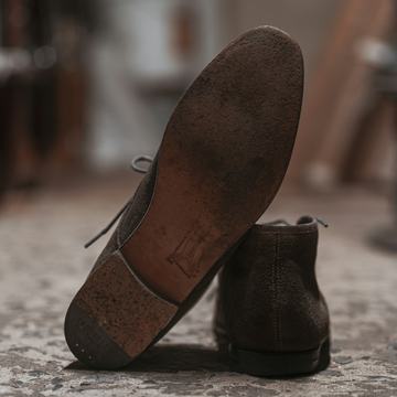 Sample photo, before: a worn-down heel on a brown leather shoe
