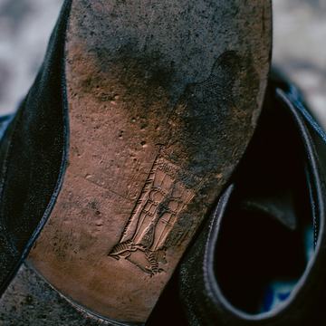 Sample photo, before: a leather sole worn through at the ball of the foot